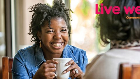 Woman smiling with coffee in hand