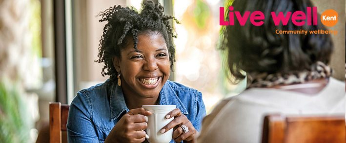 Woman smiling with coffee in hand